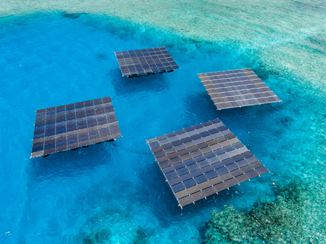 Aerial view of SolarSea floating solar power plant platforms on turquoise water over a coral reef in Dharavandhoo Baa Atoll Maldives. Aerial view of SolarSea floating solar power plant platforms on turquoise water over a coral reef in Dharavandhoo Baa Atoll Maldives.