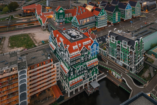Zaandam Netherlands 26 April 2022 Aerial view of Inntel Hotels Amsterdam Zaandam featuring its unique stacked traditional house facade under soft evening light.