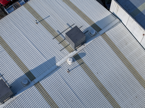 Aerial view of the industrial factory roof featuring corrugated metal panels and ventilation units in Kilsyth South Melbourne VIC Australia. Aerial view of the industrial factory roof featuring corrugated metal panels and ventilation units in Kilsyth South Melbourne VIC Australia.
