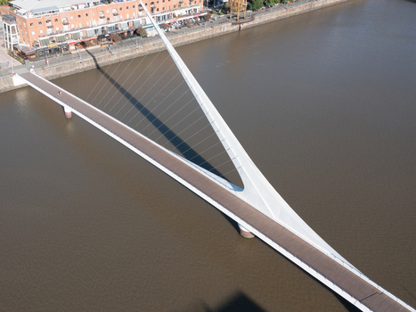 Buenos Aires Argentina 11 July 2022 Aerial view of the Puente de la Mujer bridge in the Puerto Madero district showing its white pylon and cable stayed design spanning the canal.