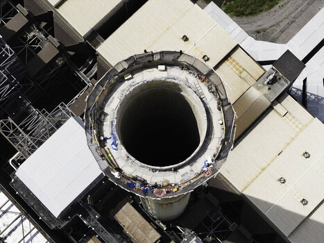 Aerial view of the exhaust stack at the Gallatin Fossil Plant showing workers on the rim of the industrial chimney structure in Gallatin TN United States.