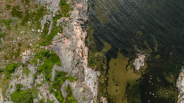 Aerial view of the rugged rocky coastline and lush green vegetation of Oro Fortress Island in Oro Varsinais Suomi Finland. Aerial view of the rugged rocky coastline and lush green vegetation of Oro Fortress Island in Oro Varsinais Suomi Finland.