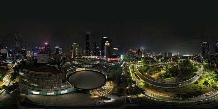 Aerial view of Plaza Semanggi and the illuminated Semanggi interchange at night surrounded by the glowing Jakarta city skyline in Kecamatan Setiabudi Daerah Khusus Ibukota Indonesia. Aerial view of Plaza Semanggi and the illuminated Semanggi interchange at night surrounded by the glowing Jakarta city skyline in Kecamatan Setiabudi Daerah Khusus Ibukota Indonesia.