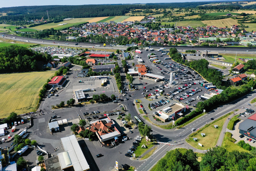 Aerial view of Eventzentrum Strohofer Geiselwind musichall and the large Autohof service station with parking lots and highway in Geiselwind Bayern Germany. Aerial view of Eventzentrum Strohofer Geiselwind musichall and the large Autohof service station with parking lots and highway in Geiselwind Bayern Germany.