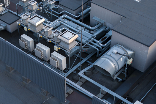 Aerial view of industrial HVAC ventilation systems and cooling units on the rooftop of an AI data center in Krakow Lesser Poland Voivode Poland. Aerial view of industrial HVAC ventilation systems and cooling units on the rooftop of an AI data center in Krakow Lesser Poland Voivode Poland.