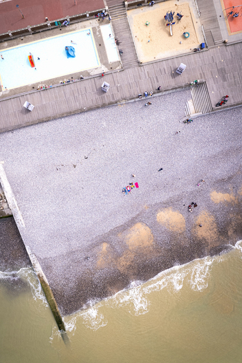 Veules les Roses Normandy France 18 June 2025 Aerial view of the beach in Veules les Roses featuring a swimming pool playground and people relaxing on the pebble shore. Veules les Roses Normandy France 18 June 2025 Aerial view of the beach in Veules les Roses featuring a swimming pool playground and people relaxing on the pebble shore.