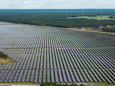 Aerial view of the solar farm at the former military airfield Preschen with rows of panels across the historic runway surrounded by forest in Neisse Malxetal Brandenburg Germany. Aerial view of the solar farm at the former military airfield Preschen with rows of panels across the historic runway surrounded by forest in Neisse Malxetal Brandenburg Germany.