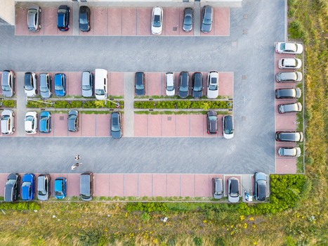 Aerial view of a parking lot with various cars parked in designated spaces surrounded by green vegetation in Zemst Flanders Belgium. Aerial view of a parking lot with various cars parked in designated spaces surrounded by green vegetation in Zemst Flanders Belgium.