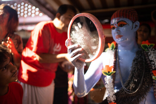 Munshiganj Bangladesh 13 April 2025 View of a serene blue deity figure its face painted in vivid orange reflected in a mirror veiled with soft white amidst a vibrant cultural gathering. Munshiganj Bangladesh 13 April 2025 View of a serene blue deity figure its face painted in vivid orange reflected in a mirror veiled with soft white amidst a vibrant cultural gathering.