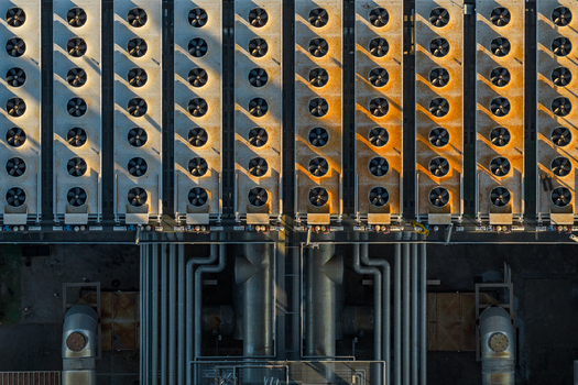 Aerial view of industrial plant with rows of cooling fans and metal pipes in Rome Lazio Italy.