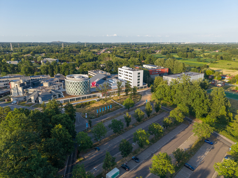 Diepenbeek Belgium 01 July 2026 Aerial view of University College Leuven Limburg Campus Diepenbeek featuring its modern circular building green grounds and parking areas. Diepenbeek Belgium 01 July 2026 Aerial view of University College Leuven Limburg Campus Diepenbeek featuring its modern circular building green grounds and parking areas.