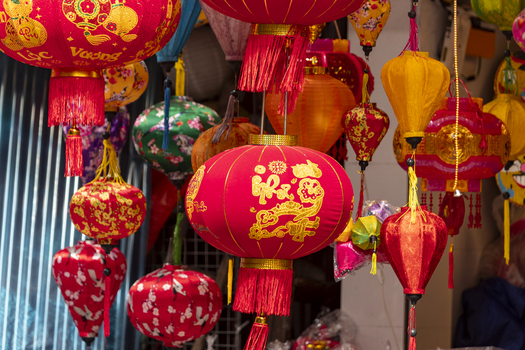 View of colorful traditional silk lanterns hanging in a market stall in Hanoi Ha Noi Vietnam.