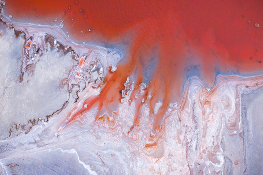 Aerial view of rust colored waters meet the stark white shoreline creating a mesmerizing dance of color and texture in this unique landscape Salt lake city Utah United States. Aerial view of rust colored waters meet the stark white shoreline creating a mesmerizing dance of color and texture in this unique landscape Salt lake city Utah United States.