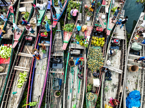 Rangamati Hill District Chittagong Division Bangladesh 18 May 2024 Aerial view of Kaptai Lake with wooden boats loaded with fresh produce and local traders working on the water.