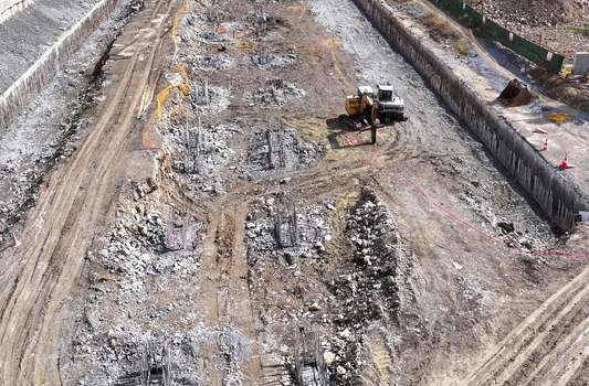 Aerial view of a large construction site with excavation work foundation rebar cages and heavy machinery in Avcilar Istanbul Turkey. Aerial view of a large construction site with excavation work foundation rebar cages and heavy machinery in Avcilar Istanbul Turkey.