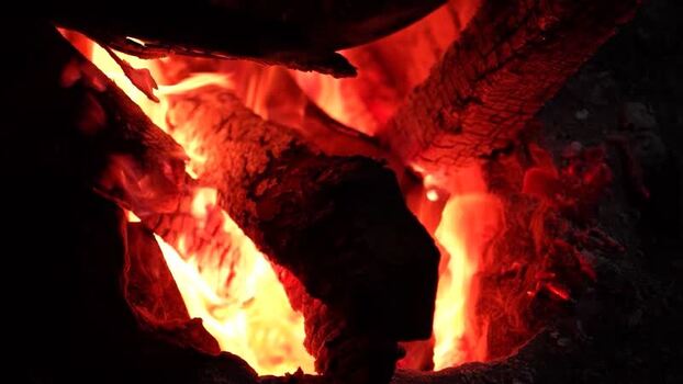 View of burning wood logs with orange flames in Bogura Bangladesh. View of burning wood logs with orange flames in Bogura Bangladesh.