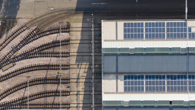 Aerial view of the Rhein Neckar Verkehr GmbH depot featuring railway tracks and solar panels on the roof in Ludwigshafen Rheinland Pfalz Germany. Aerial view of the Rhein Neckar Verkehr GmbH depot featuring railway tracks and solar panels on the roof in Ludwigshafen Rheinland Pfalz Germany.