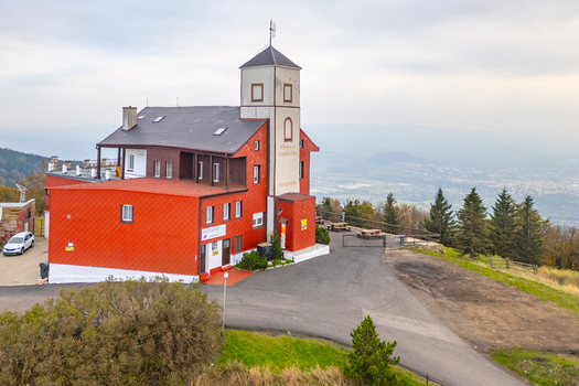 Aerial view of Komari vizka mountain hotel and observation tower with red tiled walls and panoramic views of the surrounding landscape in Krupka Usti nad Labem Region Czechia. Aerial view of Komari vizka mountain hotel and observation tower with red tiled walls and panoramic views of the surrounding landscape in Krupka Usti nad Labem Region Czechia.