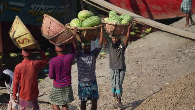 View of workers carrying watermelons at Sadarghat Bangladesh.
