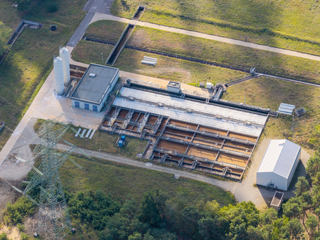 Aerial view of the Janschwalde power plant infrastructure with water treatment basins industrial buildings and a power pylon in Peitz Brandenburg Germany. Aerial view of the Janschwalde power plant infrastructure with water treatment basins industrial buildings and a power pylon in Peitz Brandenburg Germany.