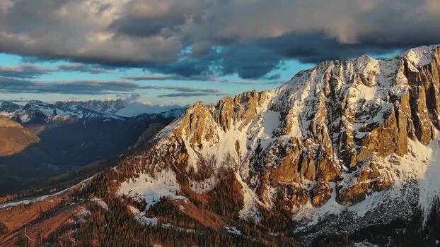Aerial view of Dolomite Mountains at golden hour Italy.