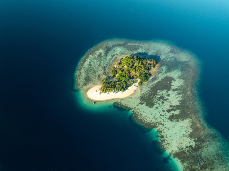 Aerial view of Pass Island surrounded by turquoise coral reefs and clear blue water in Coron Philippines. Aerial view of Pass Island surrounded by turquoise coral reefs and clear blue water in Coron Philippines.