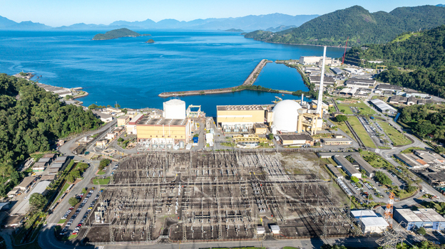 Aerial view of the Nuclear Power Plant Angra 2 with its white containment domes industrial buildings and electrical substation along the coast in Angra dos Reis Rio de Janeiro Brazil.
