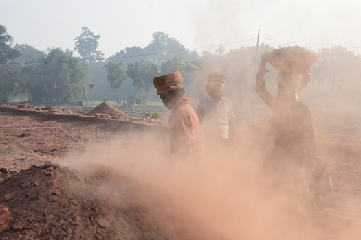 Kushtia District Khulna Division Bangladesh 28 November 2020 View of workers carrying heavy loads of bricks in a dusty brick field. Kushtia District Khulna Division Bangladesh 28 November 2020 View of workers carrying heavy loads of bricks in a dusty brick field.