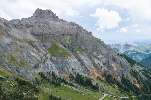 Aerial view of Mount Sneffels in the San Juan Mountains featuring rugged rocky peaks alpine slopes evergreen forests and trails in Yankee Boy Basin Ouray County Colorado United States. Aerial view of Mount Sneffels in the San Juan Mountains featuring rugged rocky peaks alpine slopes evergreen forests and trails in Yankee Boy Basin Ouray County Colorado United States.