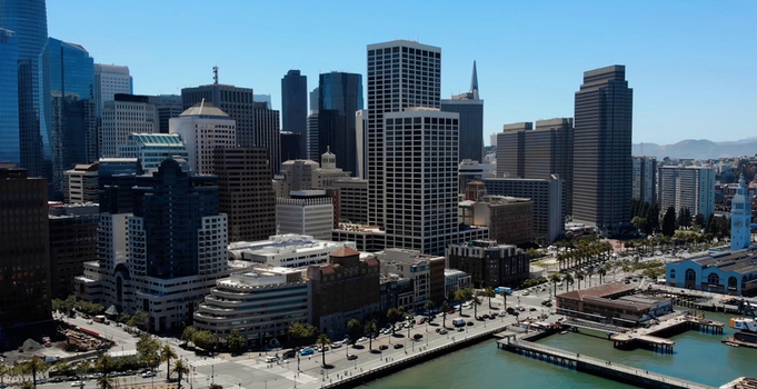 Aerial view of the Port of San Francisco with its historic waterfront buildings modern skyscrapers and the bay under a clear blue sky in San Francisco California United States. Aerial view of the Port of San Francisco with its historic waterfront buildings modern skyscrapers and the bay under a clear blue sky in San Francisco California United States.