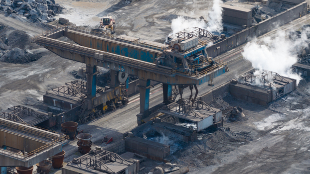 Velsen Noord Netherlands 05 May 2026 Aerial view of the Tata Steel plant featuring a large gantry crane steam rising from processing units and raw material storage areas. Velsen Noord Netherlands 05 May 2026 Aerial view of the Tata Steel plant featuring a large gantry crane steam rising from processing units and raw material storage areas.