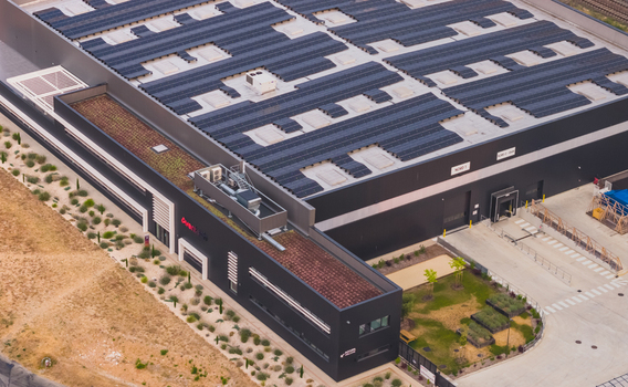 Alixan Auvergne Rhone Alpes France 25 July 2026 Aerial view of Aventech industrial facility in Rovaltain technology park with rooftop solar panels and green roof sections.