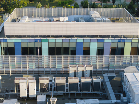 Aerial view of ai data center cooling system with rows of industrial HVAC units on a modern building rooftop in Krakow Lesser Poland Voivode Poland. Aerial view of ai data center cooling system with rows of industrial HVAC units on a modern building rooftop in Krakow Lesser Poland Voivode Poland.