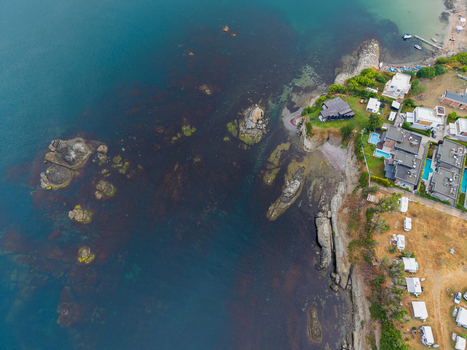 Aerial view of the rocky coastline at Arapya with modern villas swimming pools and a camping area with caravans near the sea in Burgas Bulgaria. Aerial view of the rocky coastline at Arapya with modern villas swimming pools and a camping area with caravans near the sea in Burgas Bulgaria.