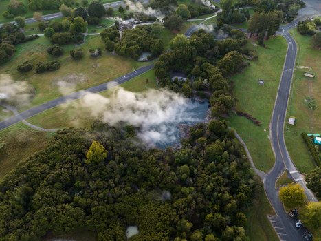 Aerial view of geothermal park where the vibrant green vegetation meets the ethereal white steam rising above the dark waters Rotorua Bay of Plenty Region New Zealand. Aerial view of geothermal park where the vibrant green vegetation meets the ethereal white steam rising above the dark waters Rotorua Bay of Plenty Region New Zealand.