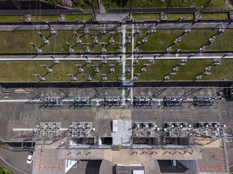 Aerial view of the electrical substation infrastructure and power lines at the Verzasca Dam in Gordola Ticino Switzerland. Aerial view of the electrical substation infrastructure and power lines at the Verzasca Dam in Gordola Ticino Switzerland.