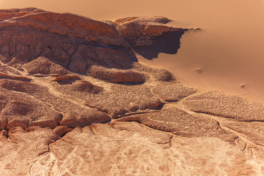 Aerial view of the rugged salt crusted terrain and sand dunes of the Valley of the Moon in the Atacama Desert San Pedro de Atacama Antofagasta Chile.