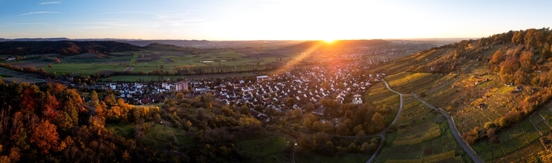 Aerial view of the village of Unterjesingen surrounded by colorful autumn vineyards and forests during a golden sunset Tubingen Baden Wurttemberg Germany. Aerial view of the village of Unterjesingen surrounded by colorful autumn vineyards and forests during a golden sunset Tubingen Baden Wurttemberg Germany.