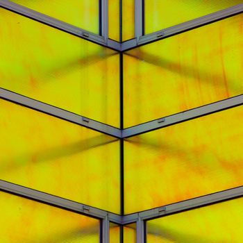 View of geometric architecture with vibrant yellow panels intersected by stark gray frames creating a dynamic contrast of color and form La Defense Flevoland Netherlands. View of geometric architecture with vibrant yellow panels intersected by stark gray frames creating a dynamic contrast of color and form La Defense Flevoland Netherlands.