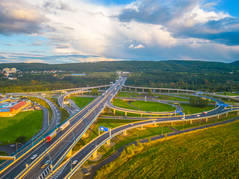 Aerial view of Lahovicky most interchange with multi level highway ramps flowing traffic green fields and surrounding landscape in Prague Hlavni mesto Praha Czechia. Aerial view of Lahovicky most interchange with multi level highway ramps flowing traffic green fields and surrounding landscape in Prague Hlavni mesto Praha Czechia.