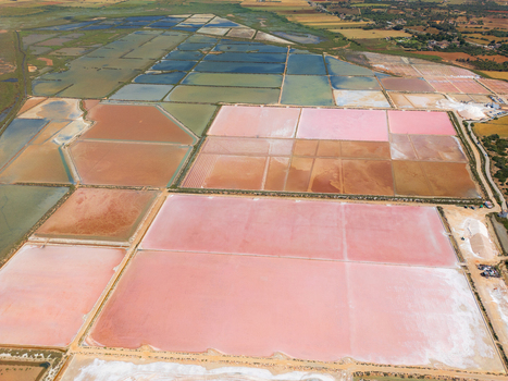 Aerial view of Salines des Trenc salt evaporation ponds with vibrant pink and blue water under bright daylight Campos Islas Baleares Spain. Aerial view of Salines des Trenc salt evaporation ponds with vibrant pink and blue water under bright daylight Campos Islas Baleares Spain.