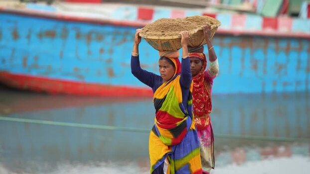 View of women carrying sand baskets in Aminbazar Bangladesh. View of women carrying sand baskets in Aminbazar Bangladesh.