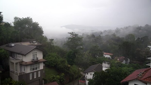 View of misty hills and residential houses in Kandy Sri Lanka.