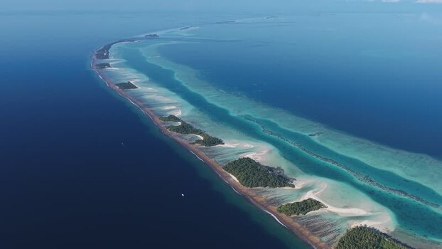 Aerial view of tropical islands and coral reefs in the Maldives.