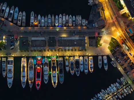 Aerial view of illuminated luxury yachts docked at Port Vauban marina at night with vibrant deck lights and waterfront infrastructure in Antibes Provence Alpes Cote d Azur France. Aerial view of illuminated luxury yachts docked at Port Vauban marina at night with vibrant deck lights and waterfront infrastructure in Antibes Provence Alpes Cote d Azur France.