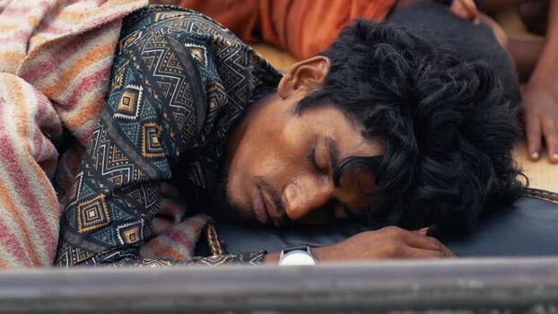 View of a man sleeping at Sadarghat river port Bangladesh.