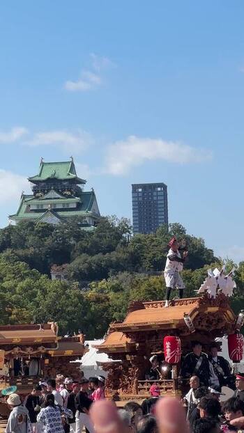 View of Osaka Castle and festival float Japan.