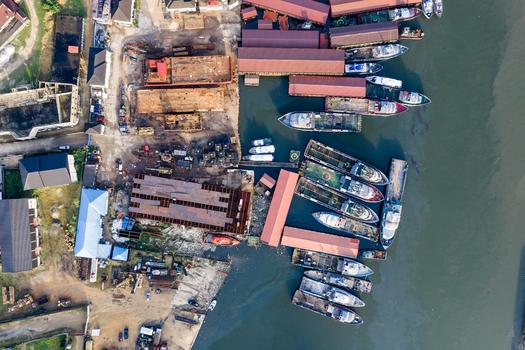 Port Harcourt Nigeria 03 July 2026 Aerial view of the shipyard in Port Harcourt with various vessels docked along the riverbank industrial structures and metal containers. Port Harcourt Nigeria 03 July 2026 Aerial view of the shipyard in Port Harcourt with various vessels docked along the riverbank industrial structures and metal containers.