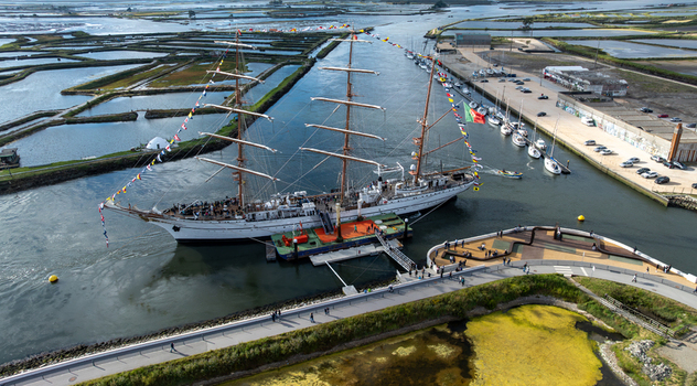 Aerial view of the tall ship NRP Sagres decorated with signal flags navigating the Canal de Aveiro near the salt pans Aveiro Aveiro Portugal. Aerial view of the tall ship NRP Sagres decorated with signal flags navigating the Canal de Aveiro near the salt pans Aveiro Aveiro Portugal.