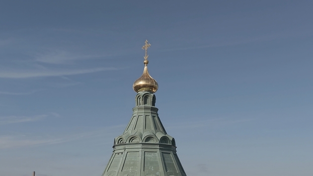 Aerial view of the golden dome and cross of Uspenski Cathedral against a clear blue sky in Helsinki Uusimaa Finland. Aerial view of the golden dome and cross of Uspenski Cathedral against a clear blue sky in Helsinki Uusimaa Finland.